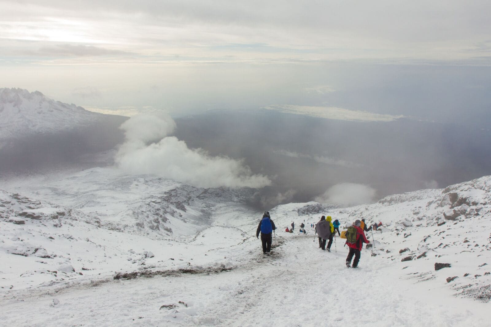 A guide leading trekkers along a Kilimanjaro ridge path
